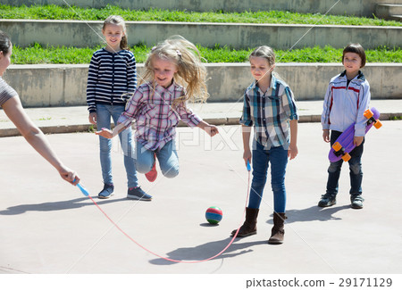 Positive girl jumping while jump rope game 29171129