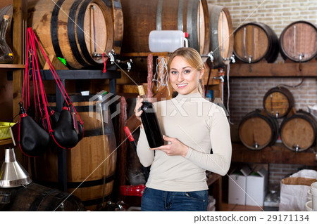 Woman having glass of wine in wine house Woman having glass of wine in wine house 29171134