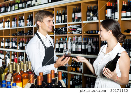 Seller in a wine house and visitor 29171180
