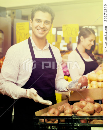 Positive smiling woman and man standing near potato 29171249