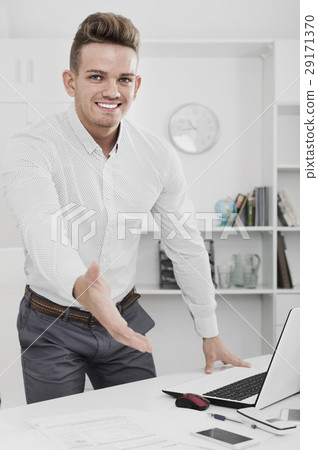 Businessman offerring hand for greeting in office 29171370