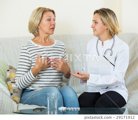 Young therapeutist and senior female with pain in belly Young therapeutist and senior female with pain in belly 29171912
