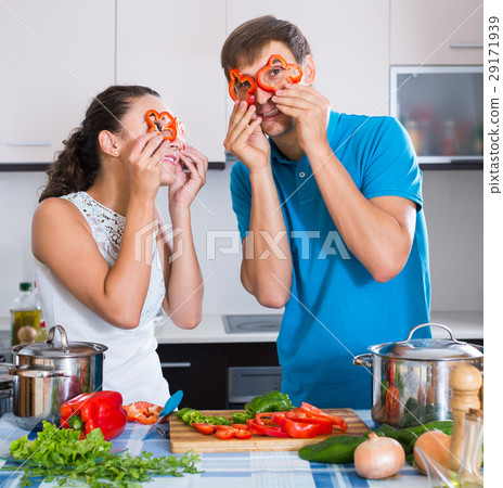 man and woman standing near table with vegetables man and woman standing near table with vegetables 29171939