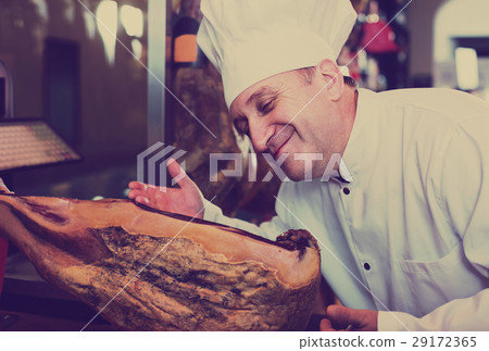 seller in deli shop with iberico and serrano jamon seller in deli shop with iberico and serrano jamon 29172365