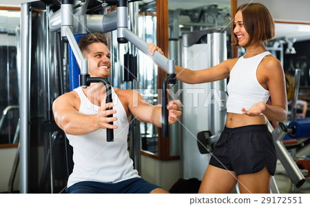 Female coach assisting man using fly machine 29172551