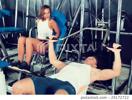 Man lifting heavy weights in press 29172722