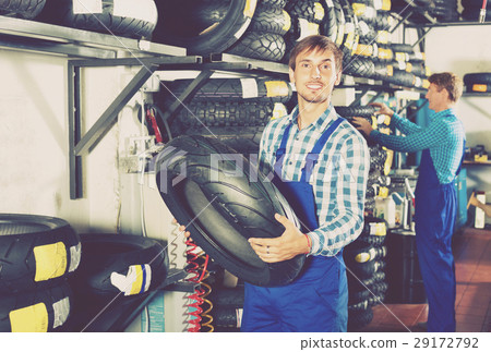 Portrait of mechanic working with bike tires in workshop Portrait of mechanic working with bike tires in workshop 29172792