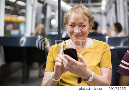 senior woman in subway phone 29173265