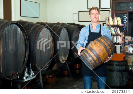 Man carrying wine wood in hands 29173324