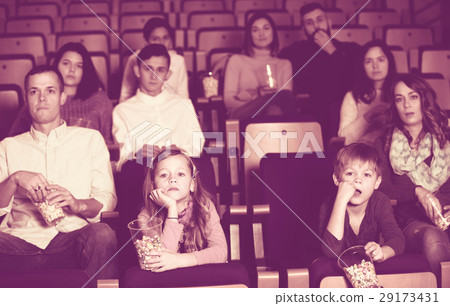 People eating popcorn in cinema 29173431