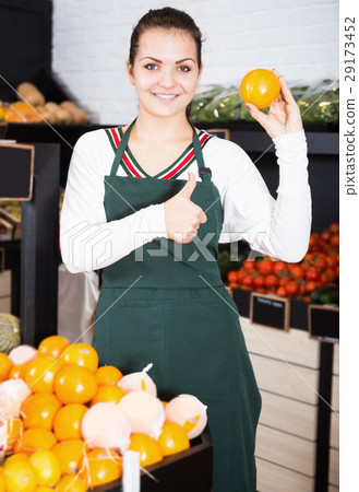 Young female seller displaying assortment 29173452