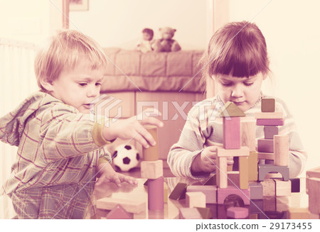 Two tranquil children playing with wooden blocks 29173455