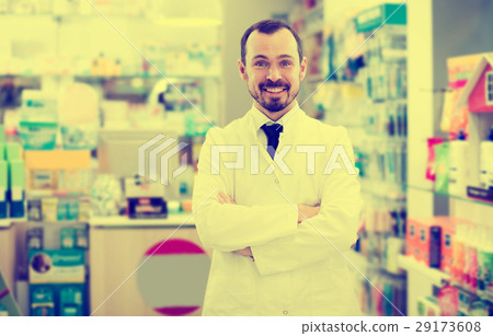Male pharmacist displaying assortment of drugs Male pharmacist displaying assortment of drugs 29173608