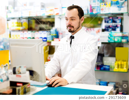 Male pharmacist checking assortment of drugs Male pharmacist checking assortment of drugs 29173609
