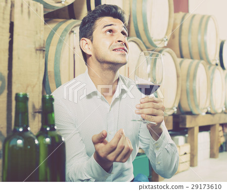 man tasting wine in cellar man tasting wine in cellar 29173610