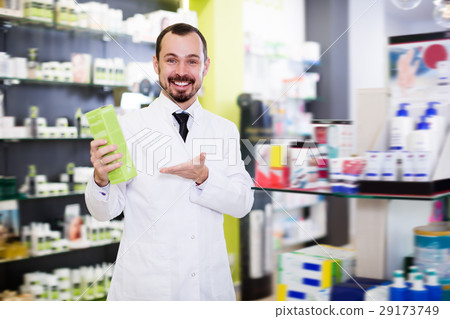 Happy pharmacist suggesting useful drug Happy pharmacist suggesting useful drug 29173749
