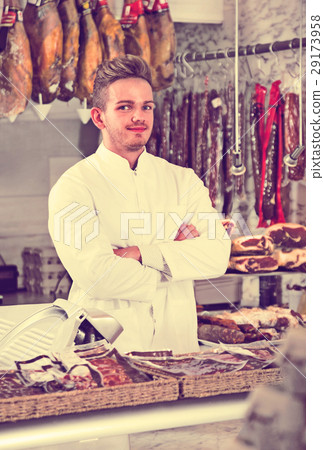 Assistant in grocery shop greeting customers Assistant in grocery shop greeting customers 29173958