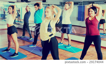 Adults having group fitness class Adults having group fitness class 29174044