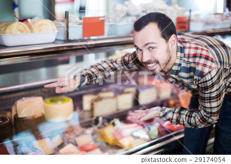 Man choosing delicious cheese Man choosing delicious cheese 29174054