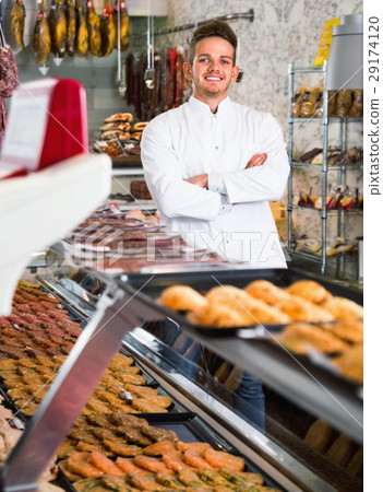 Assistant in grocery shop greeting customers 29174120