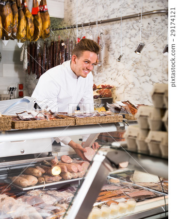 polite young seller offering fresh products polite young seller offering fresh products 29174121