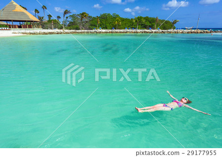 Woman floating on a back in the beautiful sea 29177955