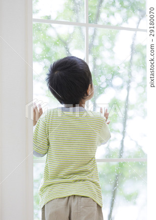 A boy looking out the window. 29180070