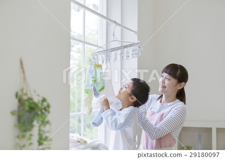 Mother and son hanging up the laundry Mother and son hanging up the laundry 29180097