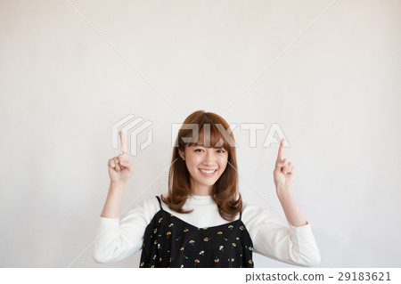 Female in her twenties pointing up 29183621