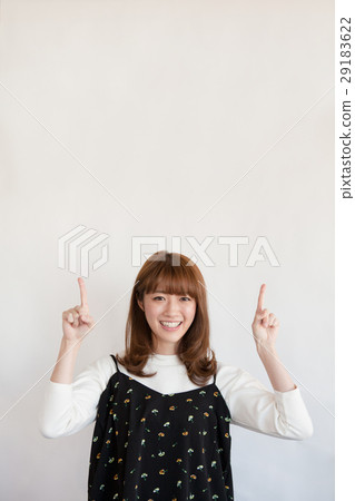 Female in her twenties pointing up 29183622