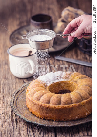 Marble cake cup of coffee and powder sugar. 29192894