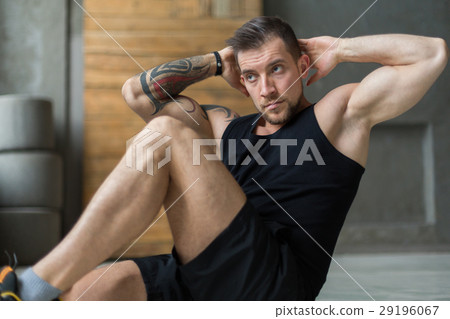 Young man fitness workout, cross crunches for abs Young man fitness workout, cross crunches for abs 29196067