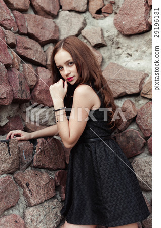 Beautiful young girl in black dress with long hair 29196181