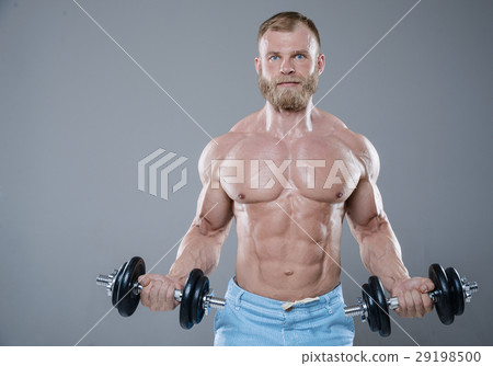 Brutal strong bodybuilder man posing in studio on grey backgroun Brutal strong bodybuilder man posing in studio on grey backgroun 29198500