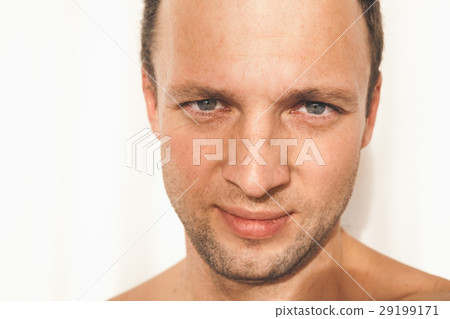 Caucasian man face over white wall Caucasian man face over white wall 29199171