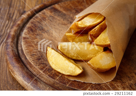Fries and potato wedges wrapped takeaway at wood 29211162