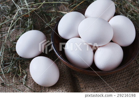 Fresh chicken white eggs on sack closeup, organic Fresh chicken white eggs on sack closeup, organic 29216198