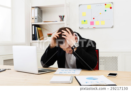 Young concentrated businessman with laptop in 29217130