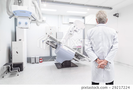 Senior doctor looking at CT scanner in hospital 29217224