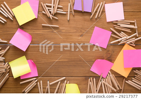 Sticky notes and color pencils on wooden desk Sticky notes and color pencils on wooden desk 29217377