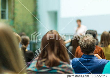 Woman giving presentation in lecture hall at 29222947