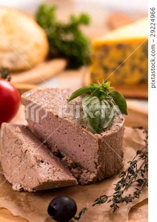Duck pate on plate with basil vertical 29224966