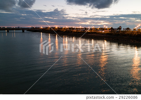 The light of the park reflected on the surface of the water 29226086