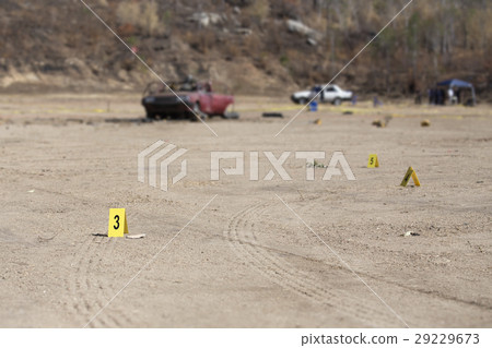 evidence marker and blurred wrecked car  29229673