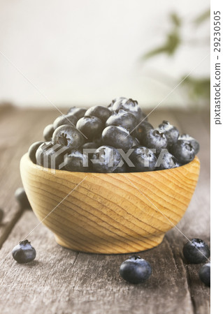 Blueberry in wooden bowl on wooden background 29230505