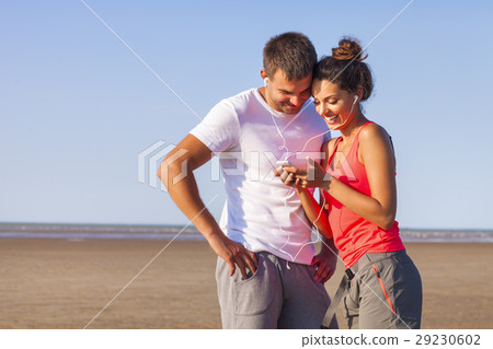 Couple listening to the music training outdoors  29230602