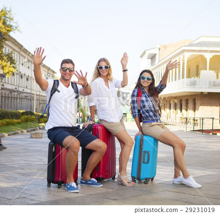 Travelers friends with luggage in the city 29231019