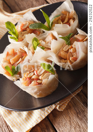 Cups of dough filo stuffed with apples and peanuts 29232022