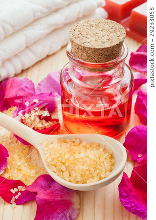 oil glass bottle, sea salt, towel and rose petals 29233058