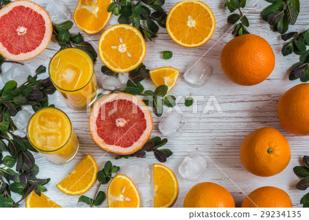 orange juice with ice in glasses near citrus and 29234135